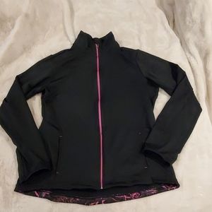 This is an Everlast black zip-up sweater with pink trim. Size Large